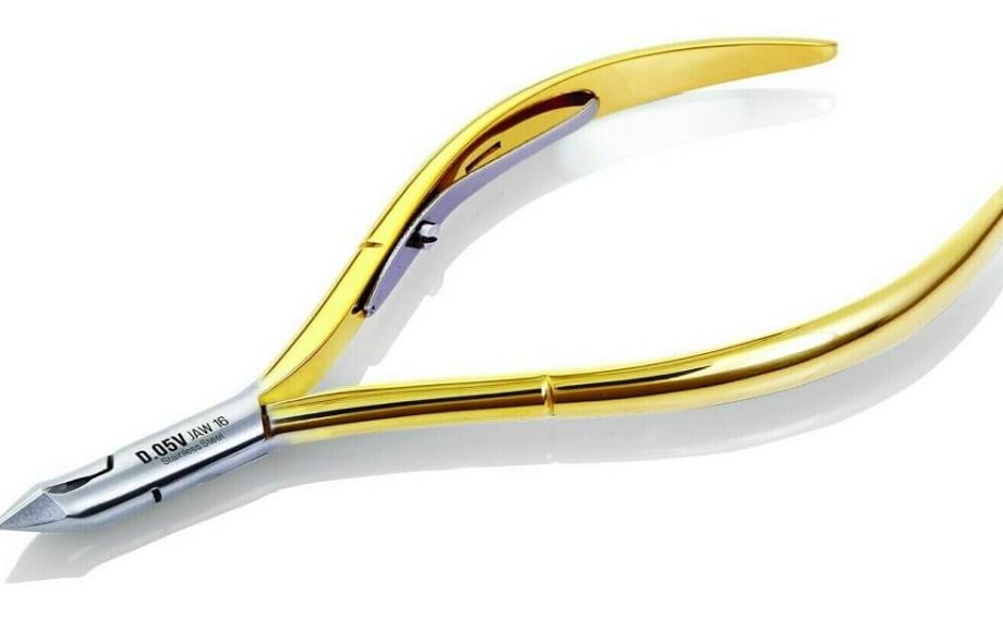 A close-up of Tweezerman Cuticle Clippers trimming cuticles, showcasing their precision and ergonomic design