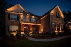 A beautifully illuminated outdoor landscape in Atlanta, showcasing well-placed lighting that enhances trees, pathways, and architectural features.