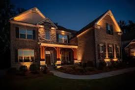 A beautifully illuminated outdoor landscape in Atlanta, showcasing well-placed lighting that enhances trees, pathways, and architectural features.